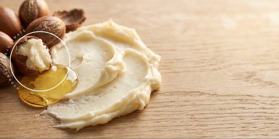 A spread of dr shea body butter laid on a wooden table showing texture and softness