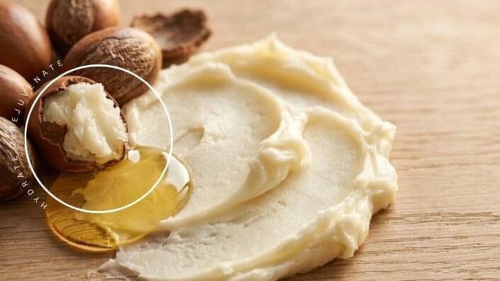 A spread of dr shea body butter laid on a wooden table showing texture and softness